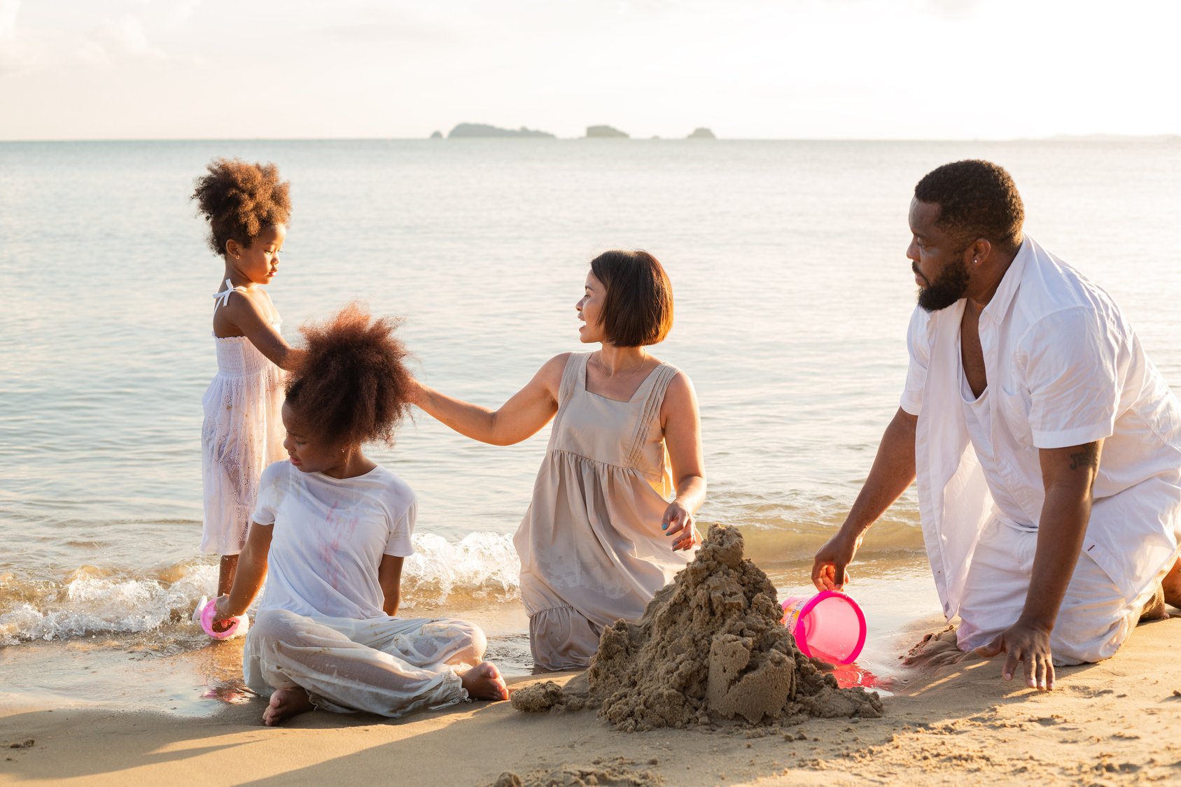 Family Building a Sand Castle at the Beach